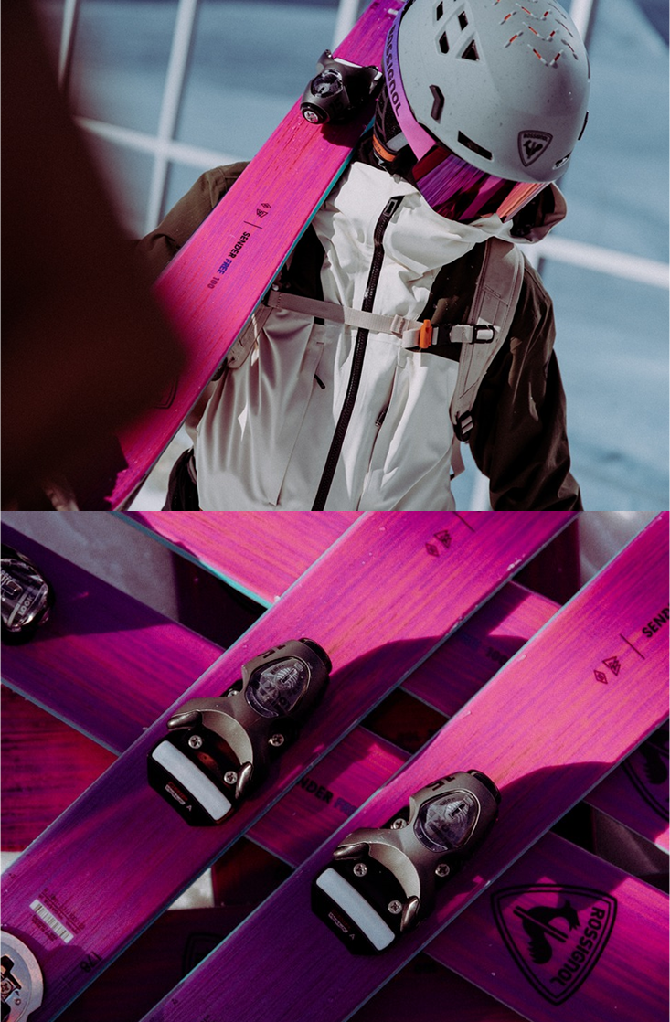 Close-up of Sender Free 100&nbsp;skis resting on the snow. Skier holding Sender Free 100 skis, equipped with the Otava Purple goggles, ready for a safe ski session.