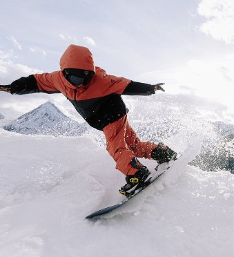 Snowboarder performing a lower body rotation with arms extended while riding