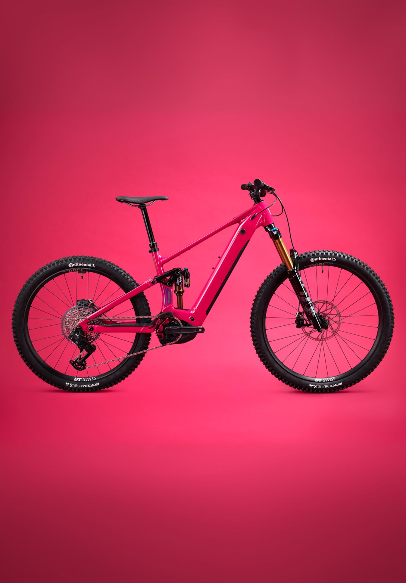 Red Rossignol After Hours electric mountain bike shown in side view, featuring full suspension, wide tires, and a sturdy frame on a plain red background.