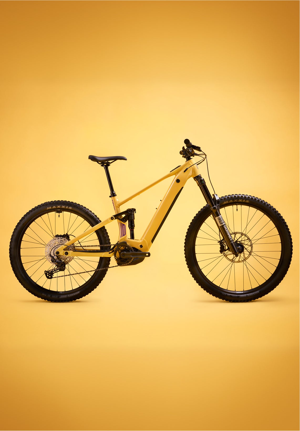 Yellow Rossignol After Hours Deore 12 electric mountain bike shown in side view, featuring full suspension, wide tires, and a sturdy frame on a plain yellow background.