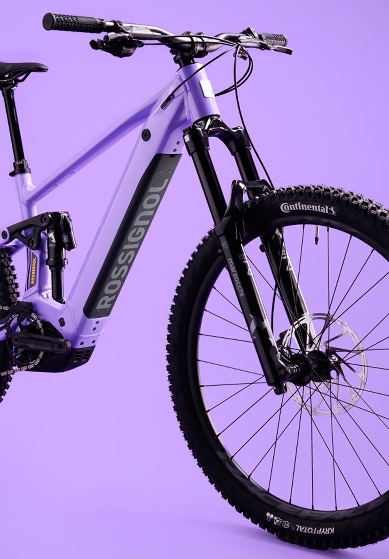 Close-up of the front section of the Rossignol After Hours Eagle 90, showing the purple frame, black suspension fork, front wheel, handlebars, and Rossignol logo on the down tube.