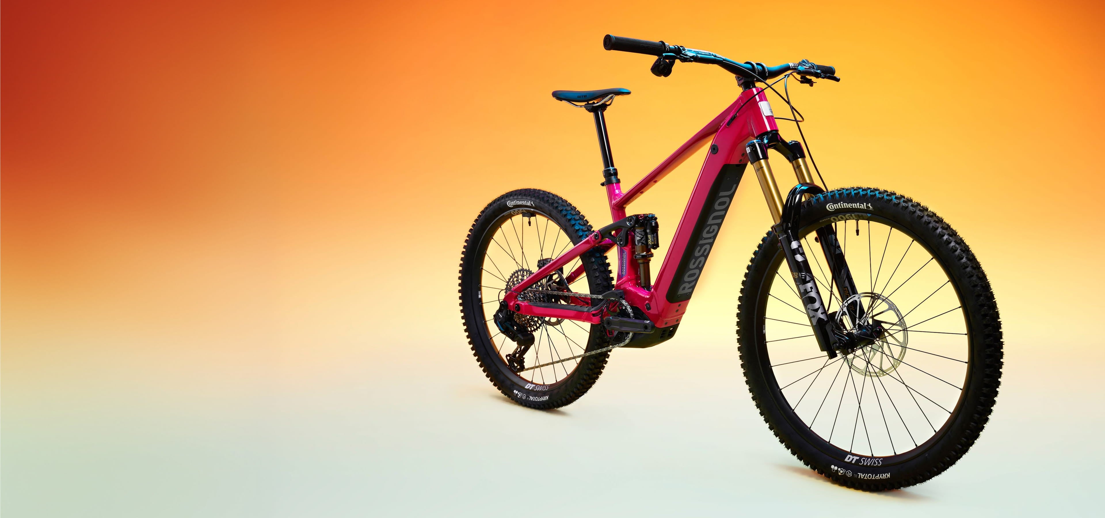 Three-quarter view of the Rossignol After Hours T-Type bike against a yellow, orange, and beige gradient background. The bike is fuchsia-colored.