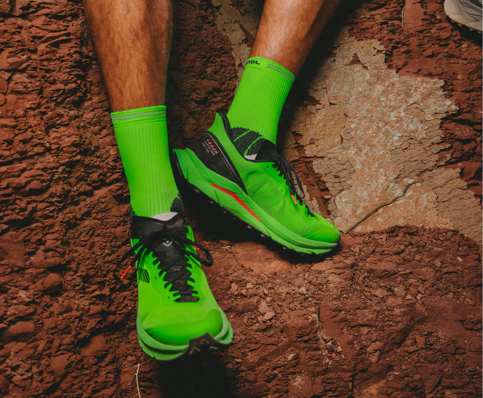 Close-up of an athlete’s Rossignol VEZOR shoes while sitting on a rock