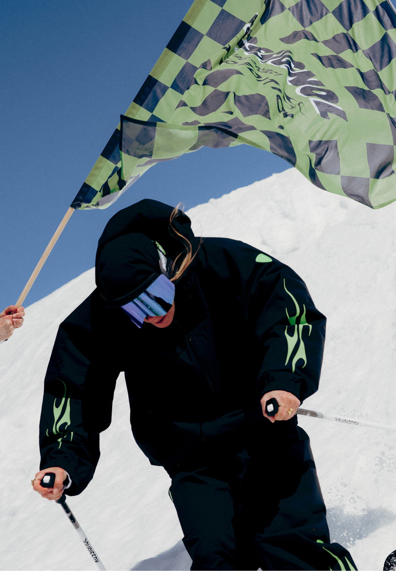 Female skier skiing downhill wearing the Rossignol ALLTRACK 2L SHELL JACKET
