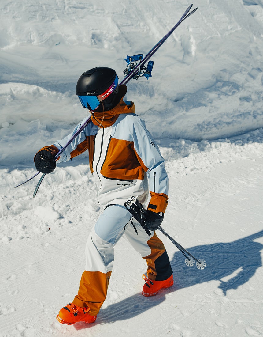 Rossignol Proclivity 3L Shell women’s ski jacket in action with ski poles in deep mountain snow