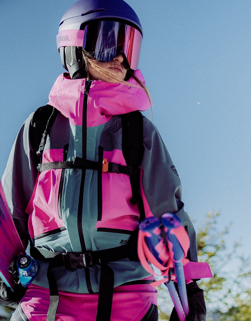 Rossignol Proclivity 3L Shell women’s ski jacket with ski gear in a snowy mountain setting