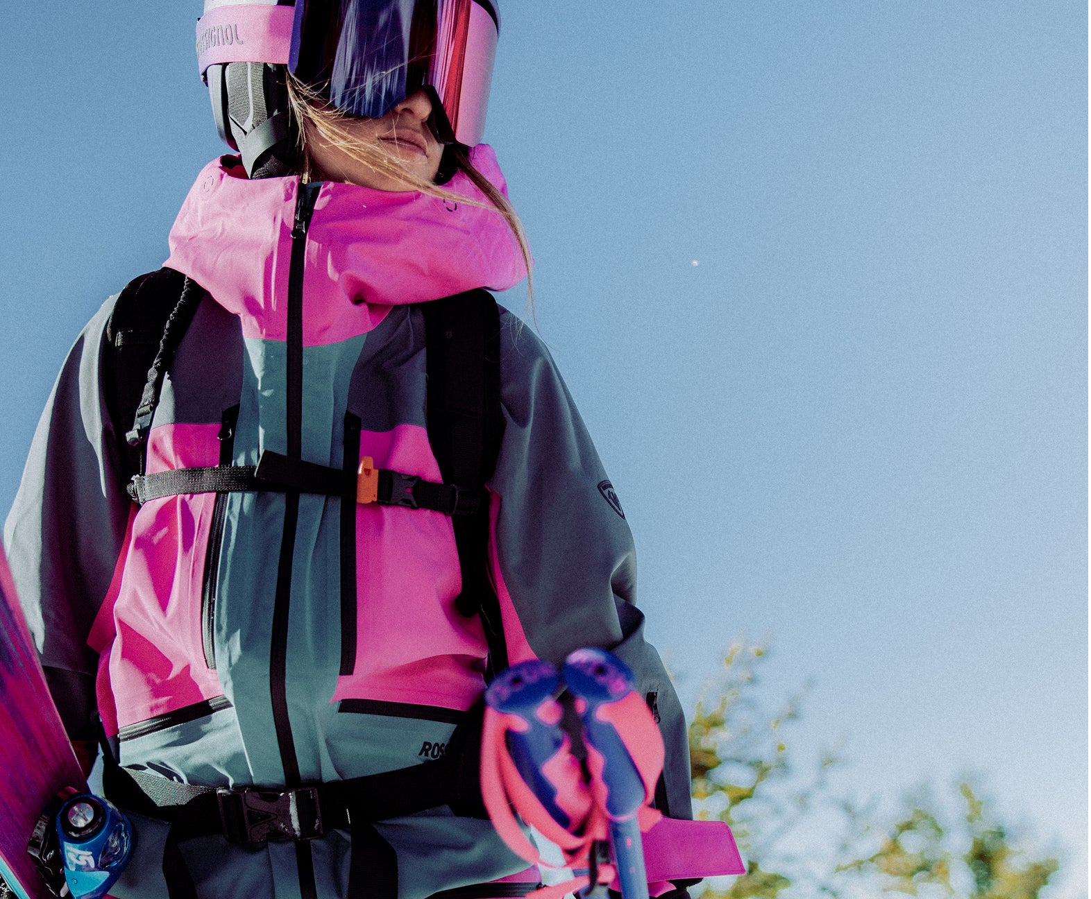 Rossignol Proclivity 3L Shell women’s ski jacket with ski gear in a snowy mountain setting