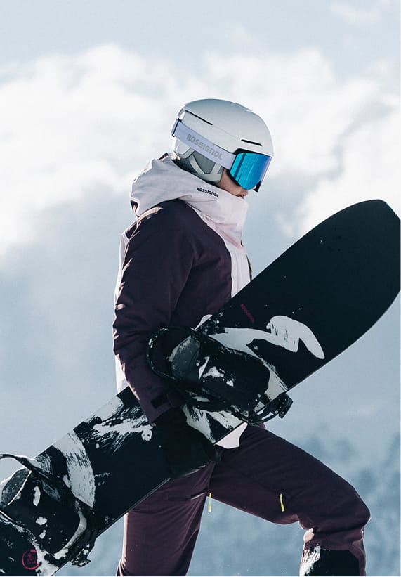 Rossignol W Outerlimits insulated ski jacket with snowboard in snowy mountain conditions