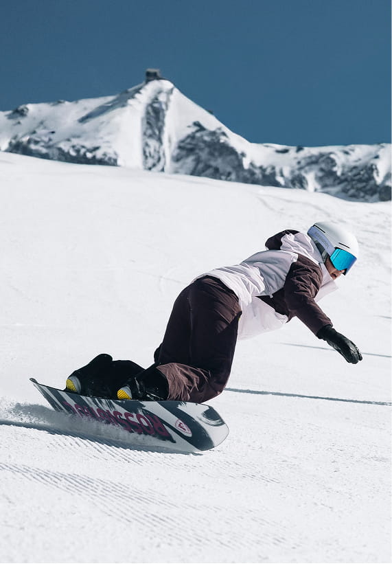 Rossignol W Outerlimits insulated ski jacket worn while snowboarding in the mountains