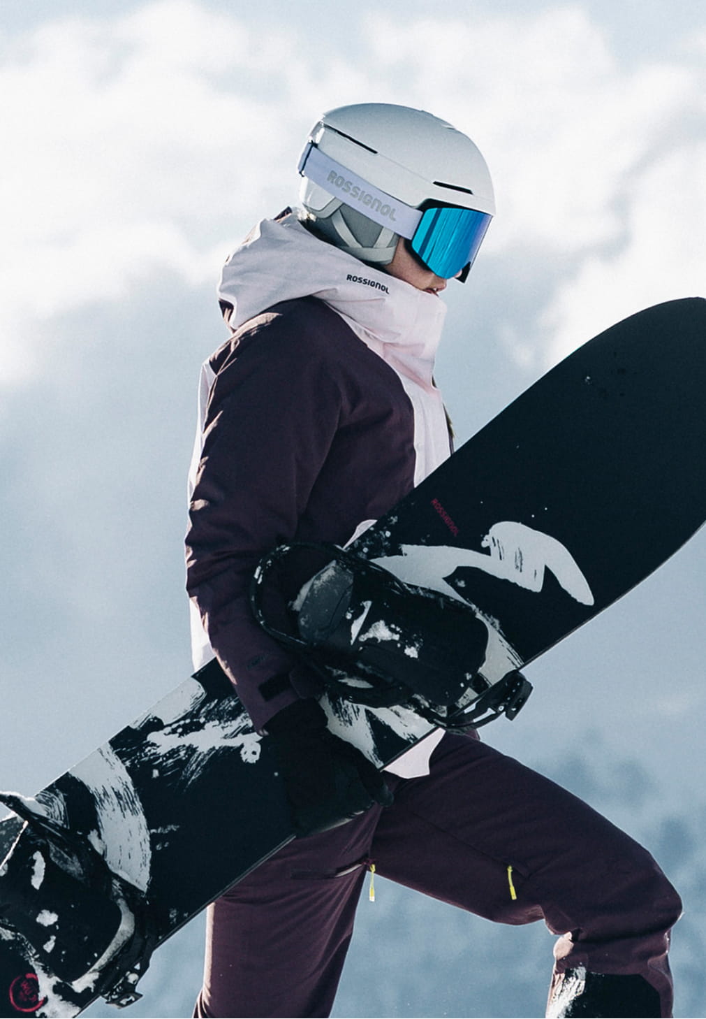 Rossignol W Outerlimits insulated ski jacket with snowboard in snowy mountain conditions