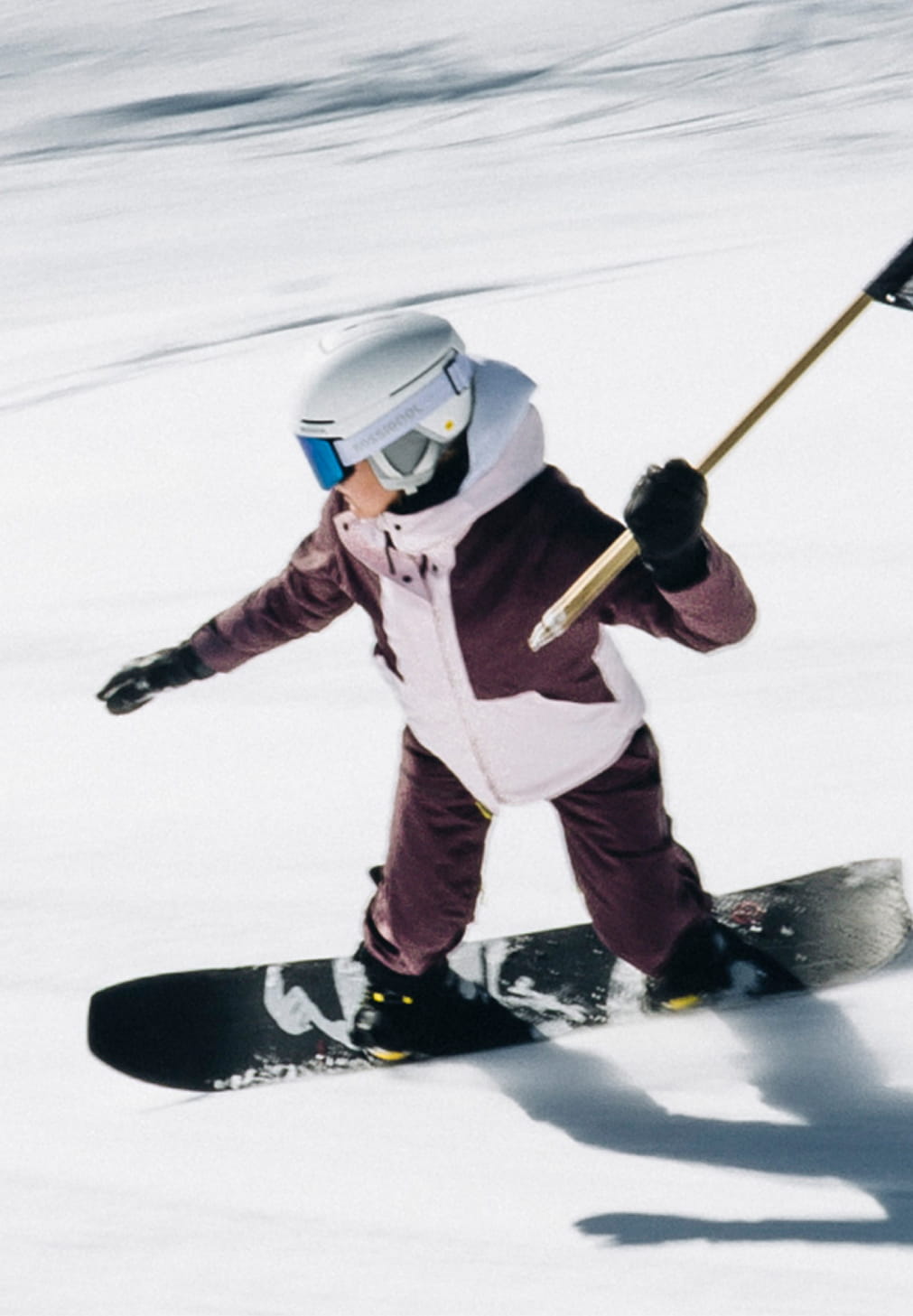 Rossignol W Outerlimits insulated ski jacket worn while snowboarding in the mountains