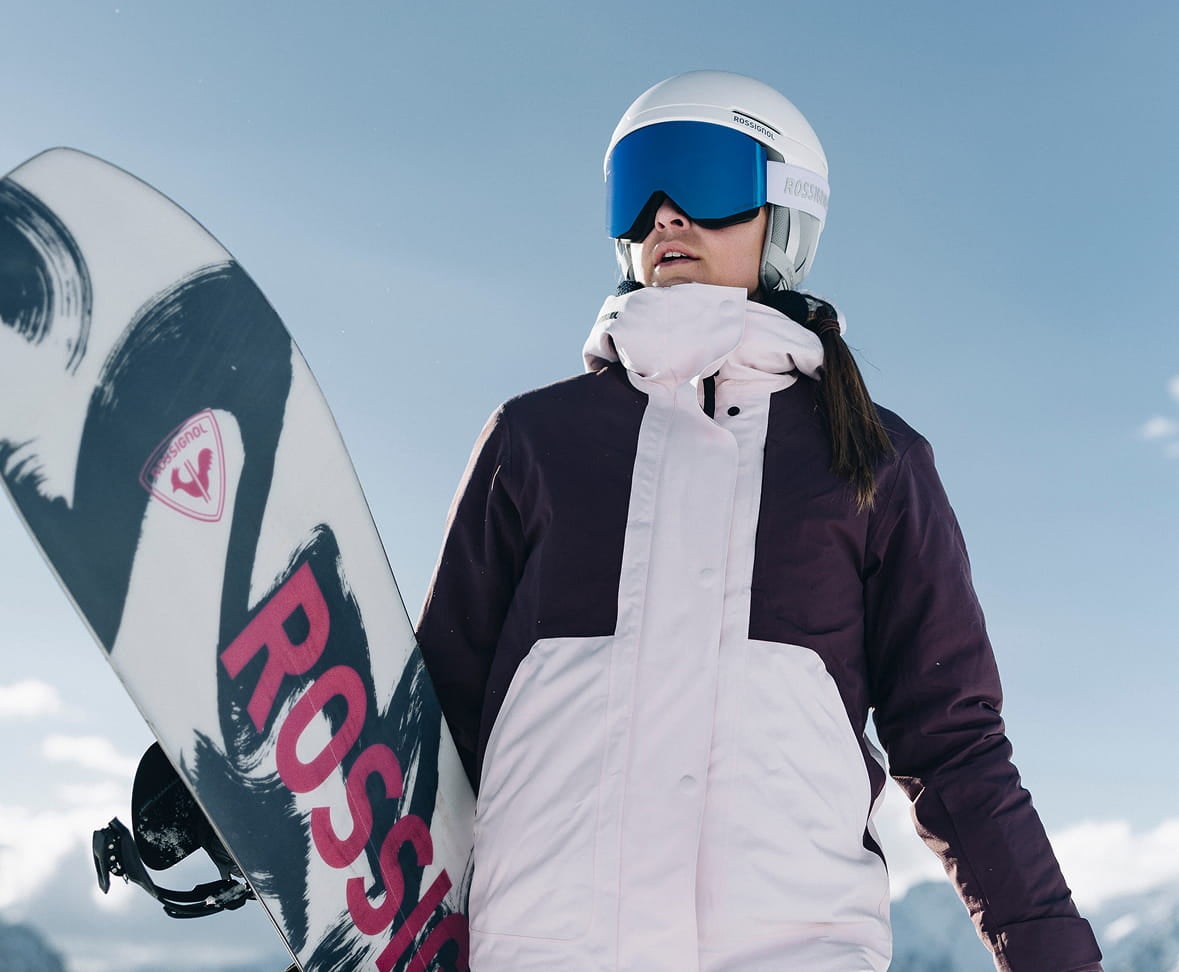  Rossignol W Outerlimits insulated ski jacket with helmet and goggles in snowy mountains