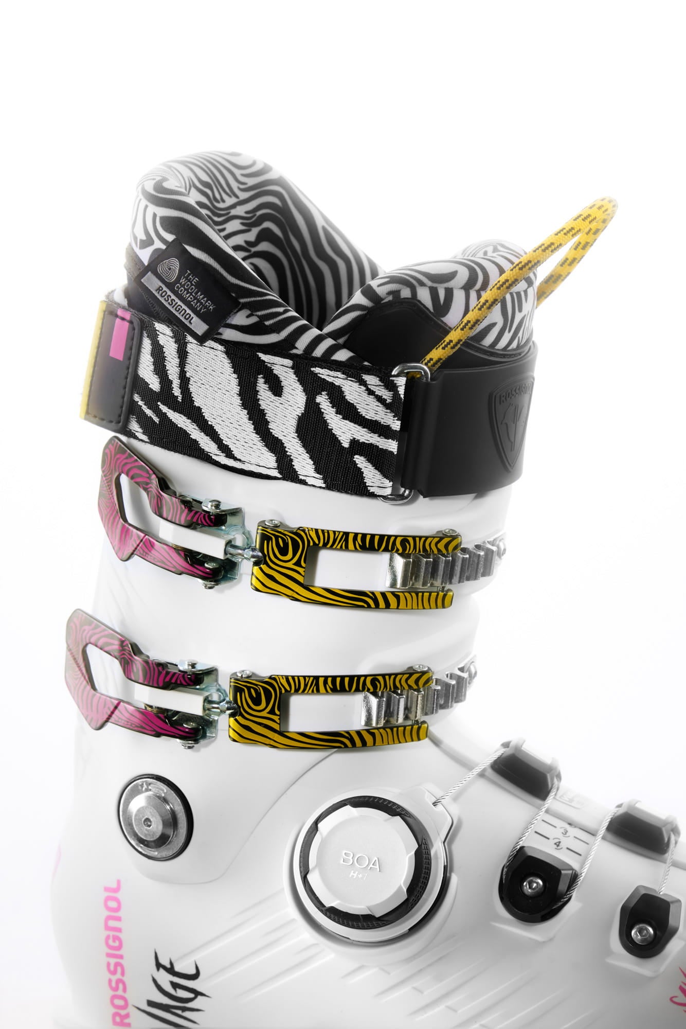 Close-up of a ski boot featuring black-and-white patterned details, with the Woolmark Company certification tag prominently displayed near the cuff.